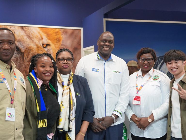 Tanzania tourism officials showcasing the Great Wildebeest Migration and calving season at the Tanzania Pavilion during the FITUR International Tourism Fair in Spain.