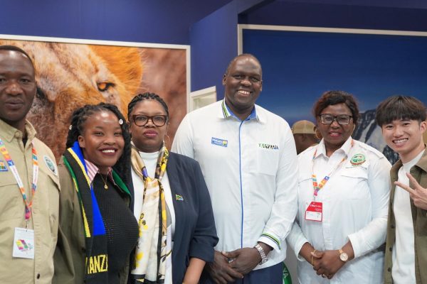 Tanzania tourism officials showcasing the Great Wildebeest Migration and calving season at the Tanzania Pavilion during the FITUR International Tourism Fair in Spain.