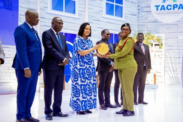 Minister Angellah Kairuki presenting awards to representatives of HESLB and the Fire and Rescue Force at JNICC in Dar es Salaam on 08 February 2026.