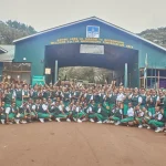 Students on an educational tour at Ngorongoro Crater observing wildlife and learning about conservation in Tanzania’s natural landscape.