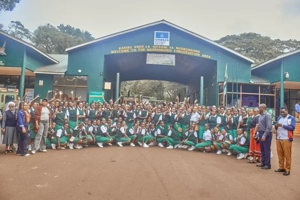 Students on an educational tour at Ngorongoro Crater observing wildlife and learning about conservation in Tanzania’s natural landscape.
