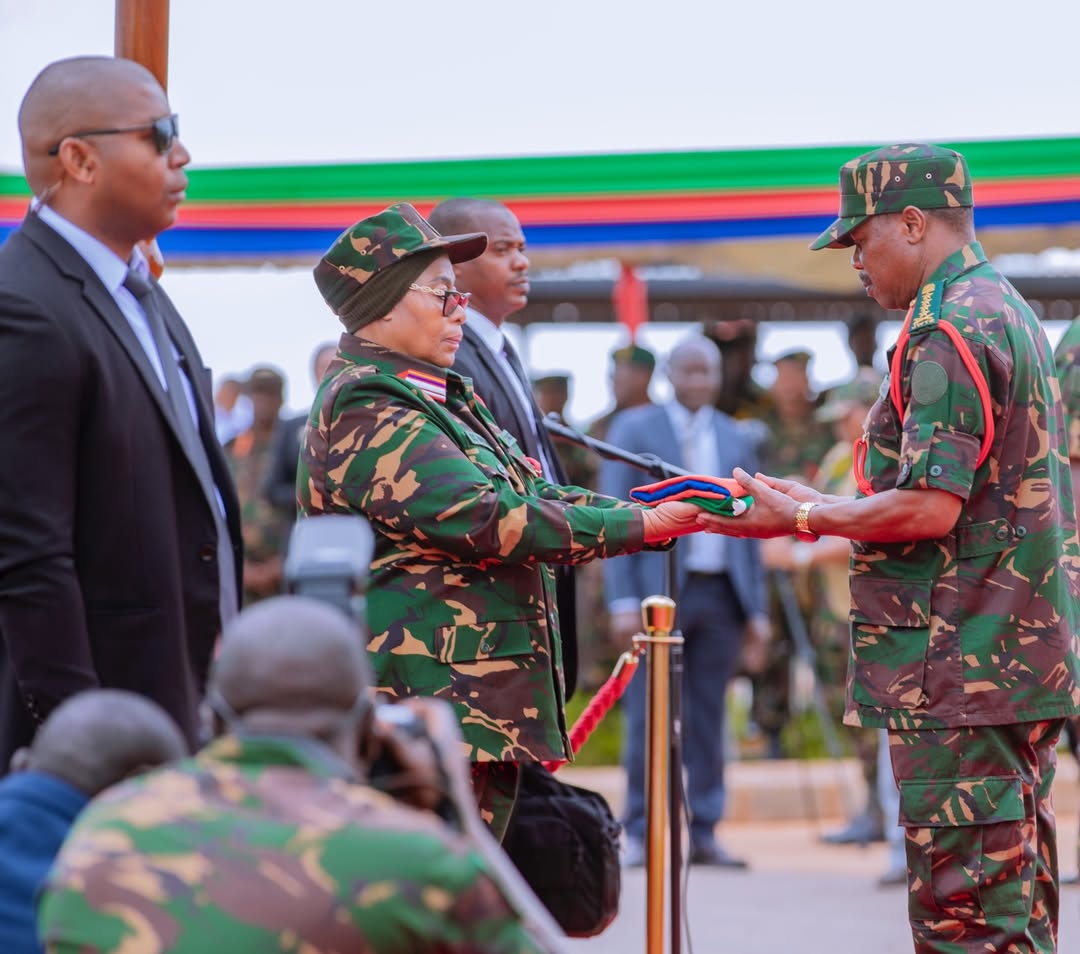 resident Samia Suluhu Hassan handing over the national flag to Chief of Defence Forces General Jacob John Mkunda at the National Defence Headquarters (MMUT) in Dodoma on 24 February 2026.