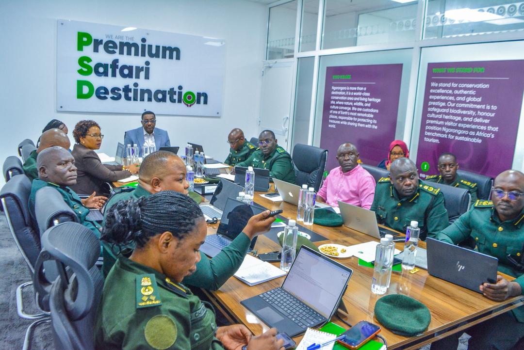 Members of the Ngorongoro Conservation Area Authority Board seated in a committee meeting reviewing performance reports for the 2025/2026 financial year.