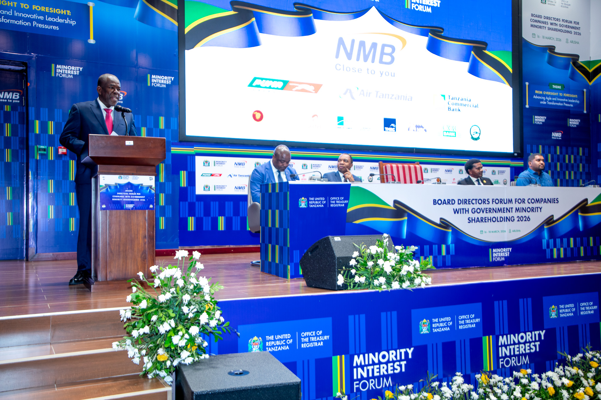 Finance Minister Khamis Mussa Omar speaking at the Minority Shareholding Companies Forum in Arusha, highlighting growth in government investment returns.