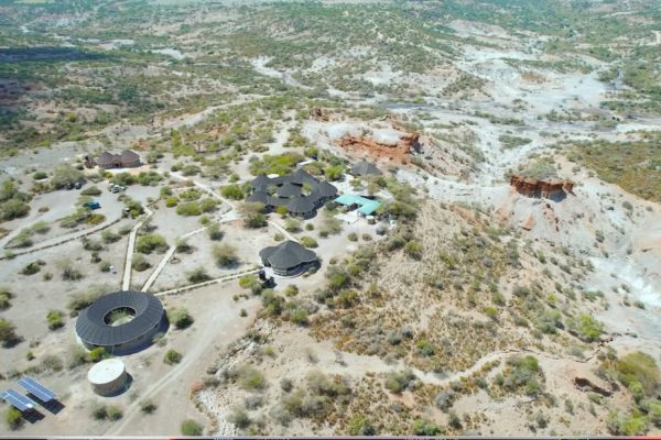 A panoramic view of Olduvai Gorge within the Ngorongoro Conservation Area, a world-renowned archaeological site known for early human fossils and stone tools.