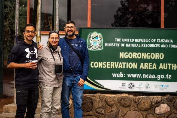 Tourists exploring Ngorongoro Crater with panoramic views from the rim and wildlife including rare black rhinos in Tanzania’s Ngorongoro Conservation Area.