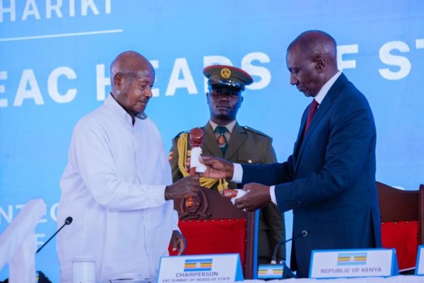Uganda President Yoweri Kaguta Museveni receiving the EAC chairmanship instruments from Kenya President William Samoei Ruto during the 25th EAC Heads of State Summit in Arusha, Tanzania.