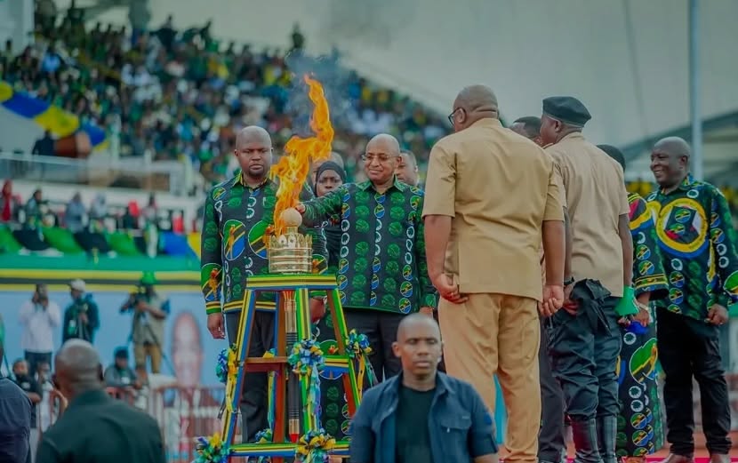 Zanzibar President Dr. Hussein Ali Mwinyi lighting the 2026 National Uhuru Torch at Gombani Stadium, Chake Chake, South Pemba, surrounded by officials and citizens