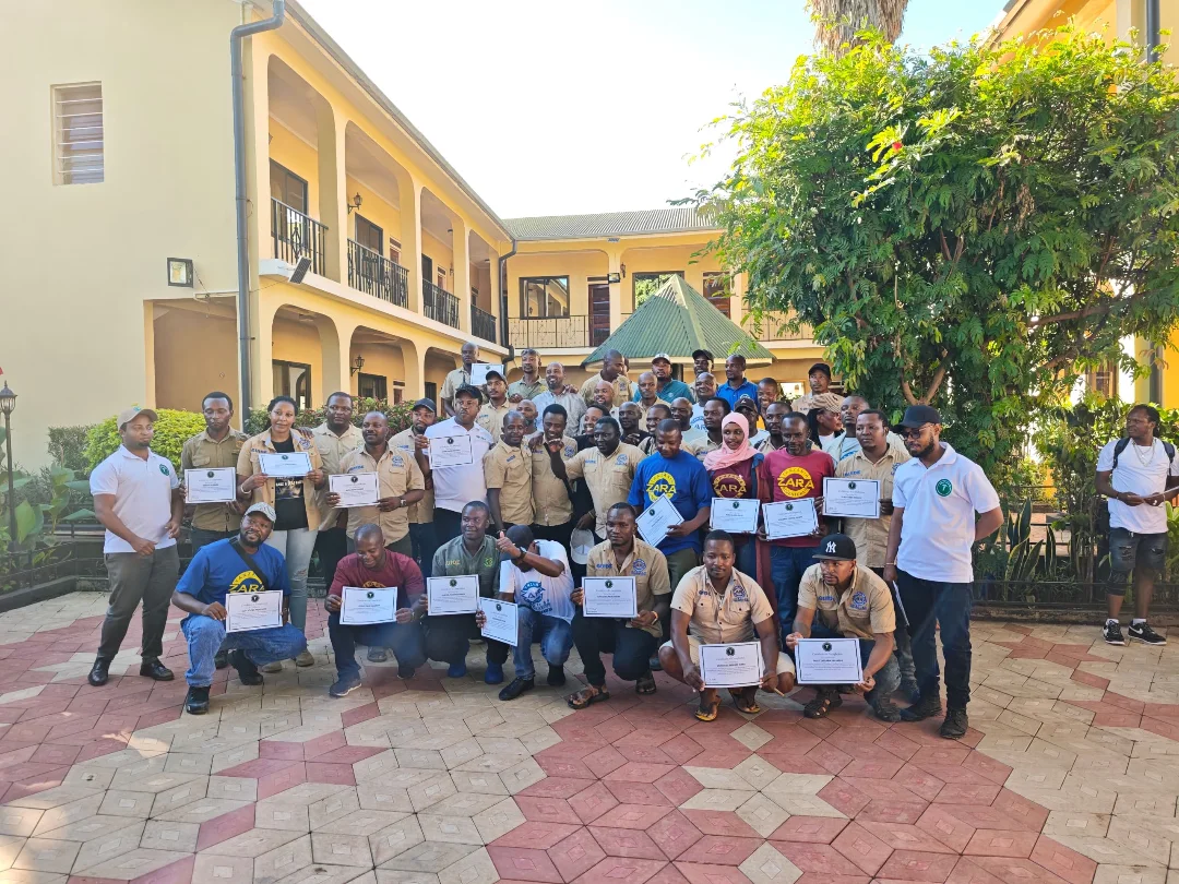 Zara Tanzania Adventures mountain and safari guides receiving certificates during a training and certification ceremony at Springlands Hotel.