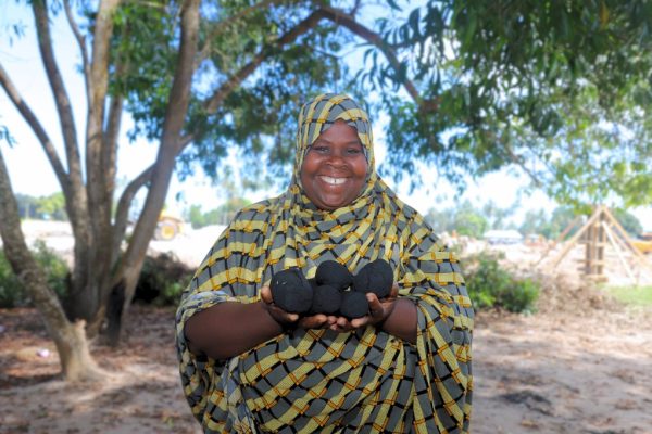 Women in Zanzibar producing eco-friendly briquettes from household and agricultural waste as part of a clean energy and climate resilience initiative supported by UN Women Tanzania.