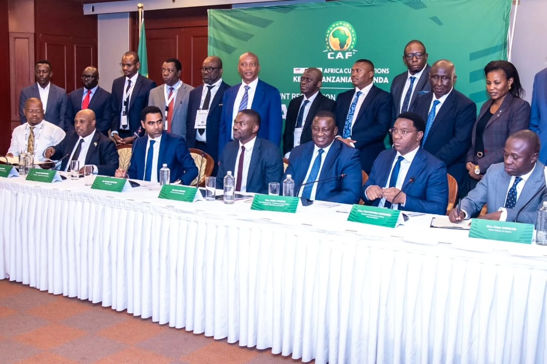 Representatives from Tanzania, Kenya and Uganda signing the CAF Joint Resolution – TotalEnergies AFCON PAMOJA 2027 in the presence of Patrice Motsepe during the official ceremony.