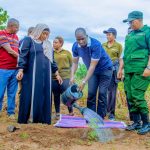 Kilombero District Commissioner Advocate Dunstan Kyobya and community members participate in a tree-planting exercise during World Environment Day celebrations in Kilombero, supporting Tanzania’s Vision 2050 environmental conservation campaign.
